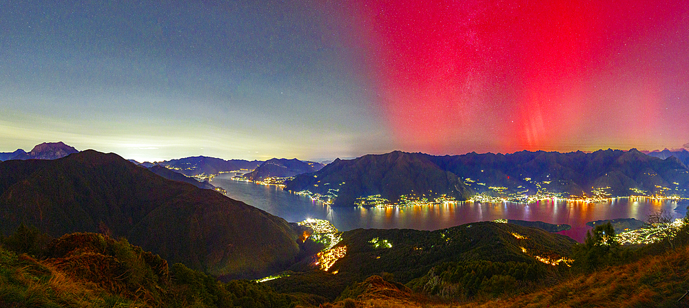 Lake Como and mountains under the Aurora Borealis, Como province, Lombardy, Italy
