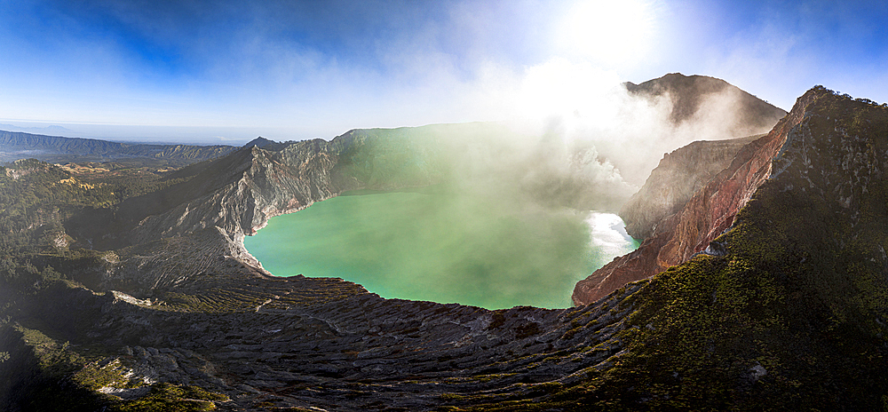 Aerial view of smoke above the turquoise lake on crater of Kawah Ijen volcano, Banyuwangi, East Java, Indonesia