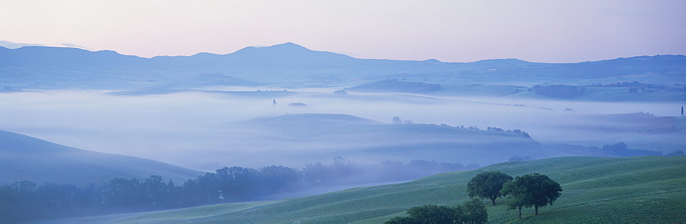 Misty dawn view across Val d'Orcia towards the Belvedere, near San Quirico d'Orcia, Tuscany, Italy, Europe