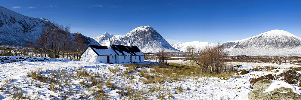 Panoramic view of Black Rock Cottage with Buachaille Etive Mor in distance on snow covered Rannoch Moor, near Fort William, Highland, Scotland, United Kingdom, Europe