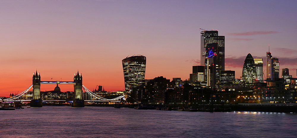 Panoramic view of Tower Bridge framing St. Paul's Cathedral with the City tower blocks at sunset, London, England, United Kingdom, Europe