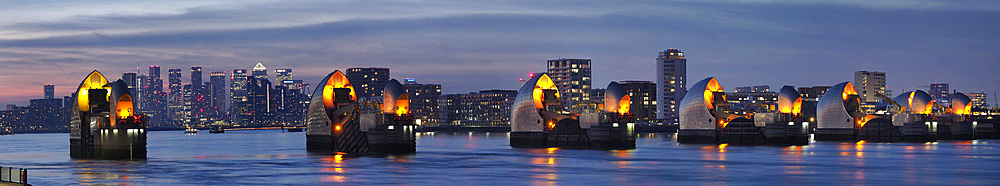 Thames Barrier dusk panorama with Canary Wharf beyond, London, England, United Kingdom, Europe