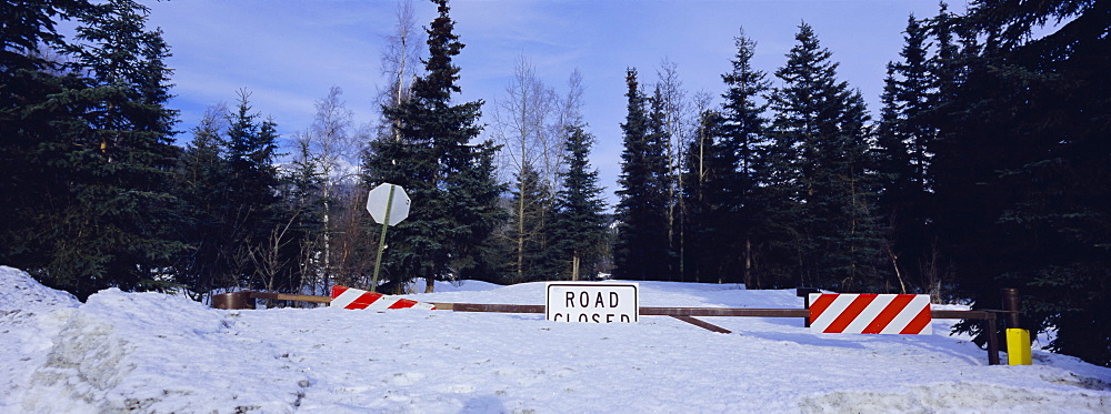 Road closed sign and deep snow, Alaska, USA, North America