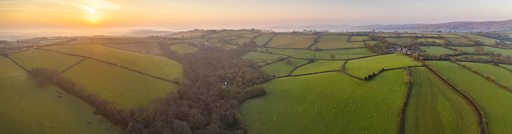 View by drone of early Spring sunrise over the rolling countryside of Devon, England, United Kingdom, Europe