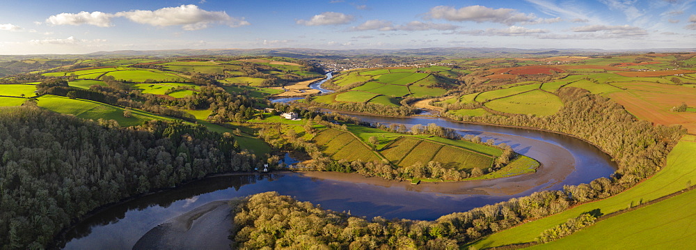 Aerial vista by drone of the River Dart meandering through rolling countryside, Devon, England, United Kingdom, Europe