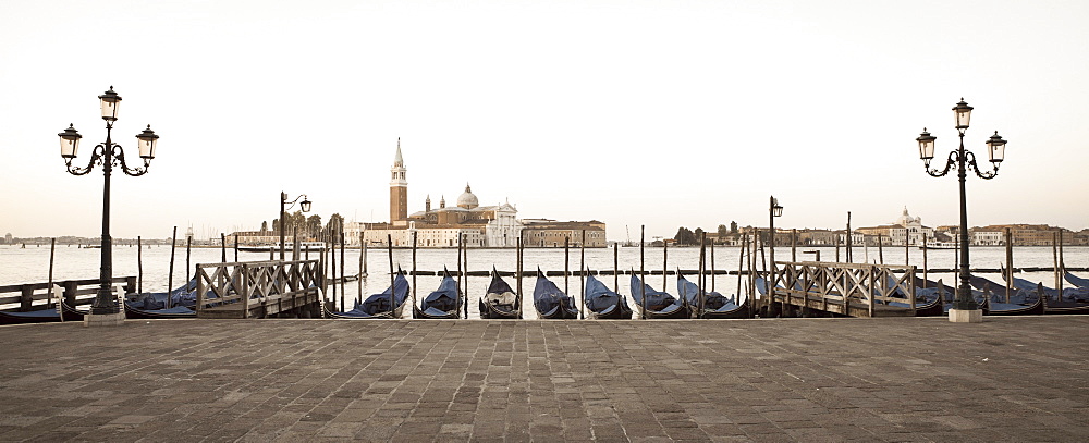 Gondolas moored on the Lagoon, San Giorgio Maggiore beyond, Riva degli Schiavoni, Venice, UNESCO World Heritage Site, Veneto, Italy, Europe