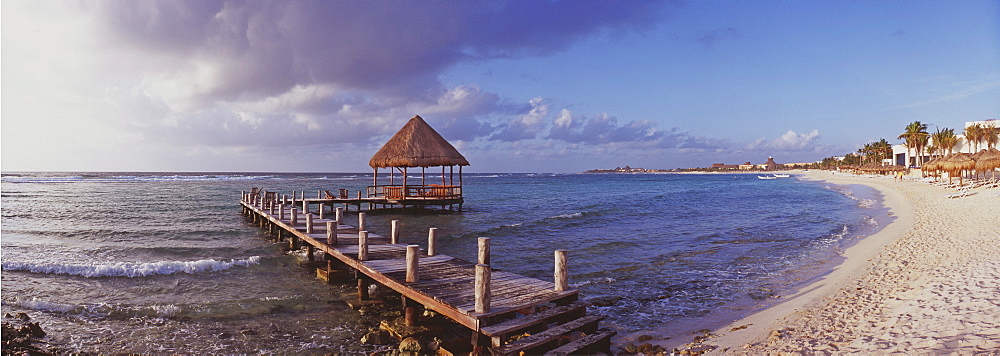 Pier with palapa jutting out into the water from the beach, Mayan Riviera, Akumal, Yucatan, Quintana Roo, Mexico, North America