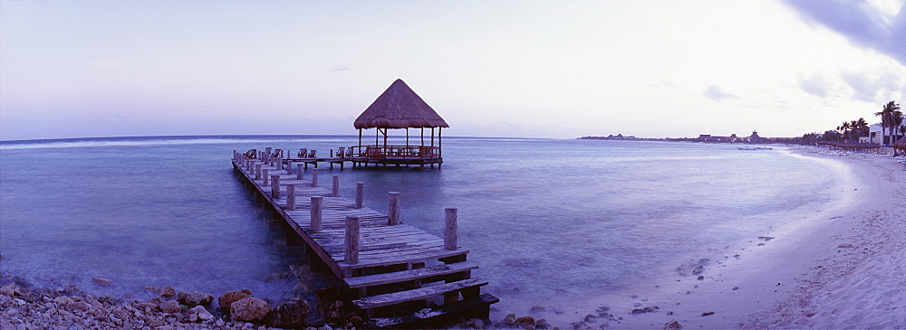 Pier with palapa jutting out into the water from the beach, Mayan Riviera, Akumal, Yucatan, Quintana Roo, Mexico, North America