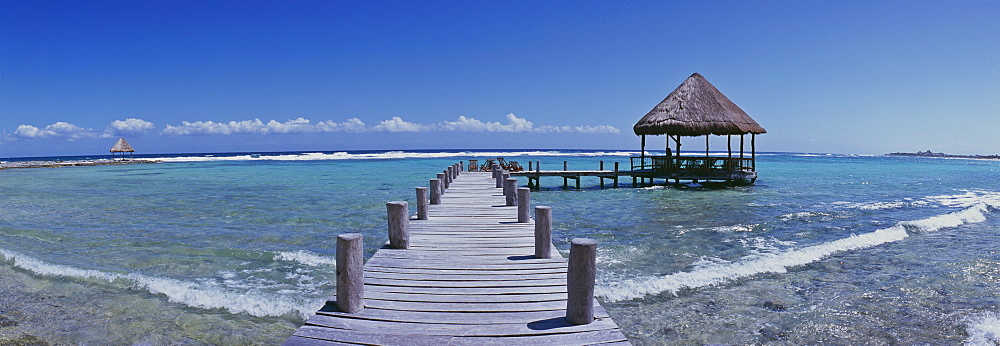 Pier with palapa jutting out into the water from the beach, Mayan Riviera, Akumal, Yucatan, Quintana Roo, Mexico, North America