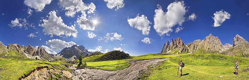 360Â¬âˆž panoramic view of the Geisler Mountains, two hikers walking near Mittagsscharte gorge, Puez-Geisler Nature Park, province of Bolzano-Bozen, Italy, Europe