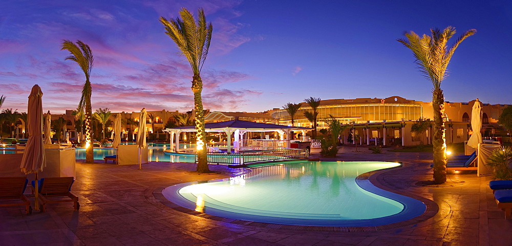 Swimming pool with palm trees at sunset, Hilton Nubian Resort, Al Qusair, Marsa Alam, Egypt, Africa