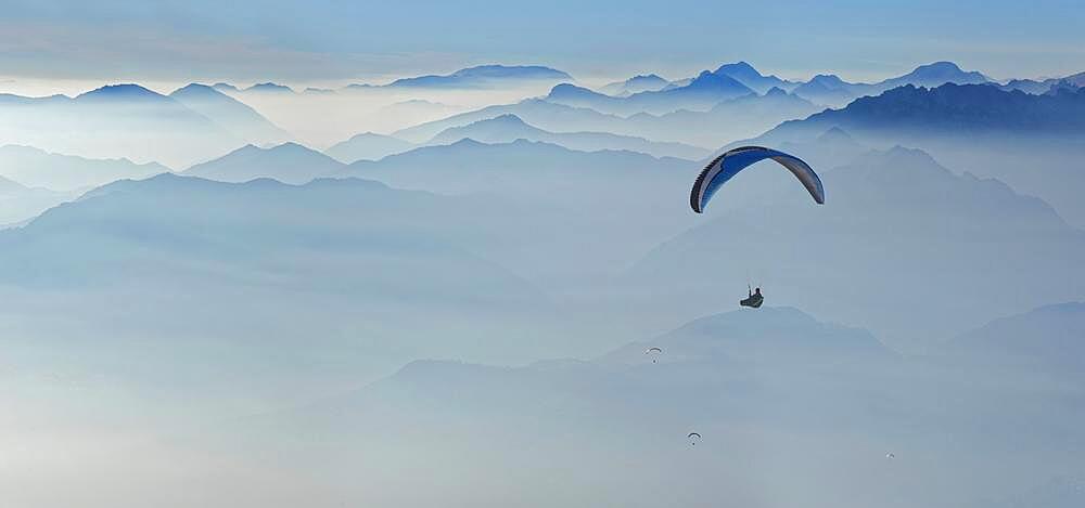 Paragliding with the peaks of the Garda Mountains and Bergamo Alps, Monte Baldo, Malcesine, Verona Italy, Trentino-Alto Adige, Italy, Europe