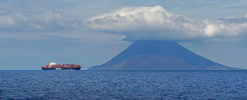 Container ship in front of the island and volcano Stromboli, Stromboli, Calabria, Italy, Europe