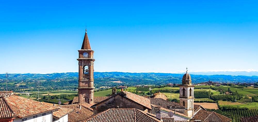 GOVONE, ITALY - CIRCA AUGUST 2020: Piedmont hills in Italy, Monferrato area. Scenic countryside during summer season with vineyard field. Wonderful blue sky in background