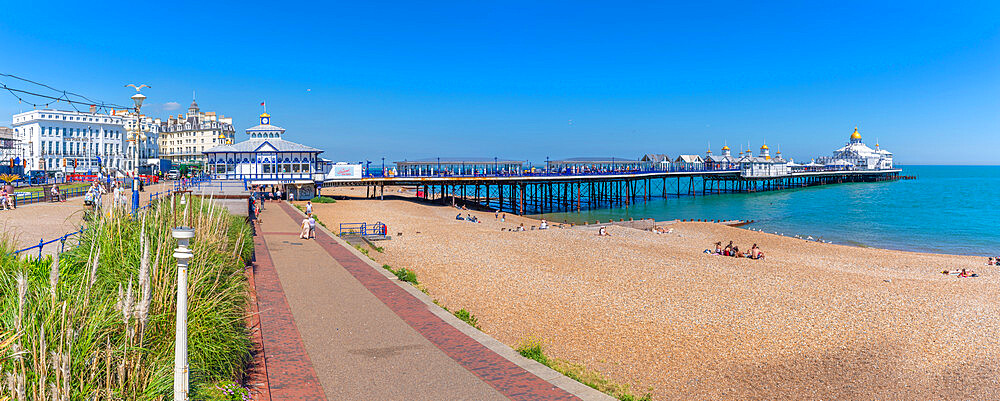 View of sea front promenade, pier and beach in summer time, Eastbourne, East Sussex, England, United Kingdom, Europe