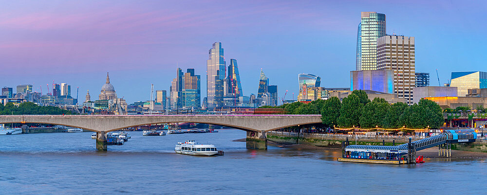 View of Waterloo Bridge over the River Thames, St. Paul's Cathedral and The City of London skyline at dusk, London, England, United Kingdom, Europe