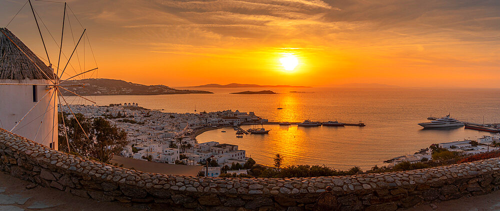 View of windmill overlooking town at golden sunset, Mykonos Town, Mykonos, Cyclades Islands, Greek Islands, Greece, Europe