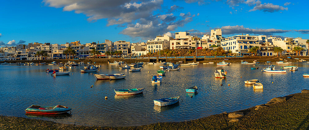 View of boats in Baha de Arrecife Marina surrounded by shops, bars and restaurants at sunset, Arrecife, Lanzarote, Canary Islands, Spain, Atlantic, Europe