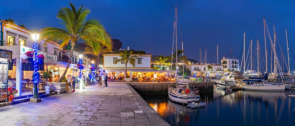 View of cafes and restaurants, Puerto de Mogan and mountainous background at dusk, Puerto de Mogan, Gran Canaria, Canary Islands, Spain, Atlantic, Europe