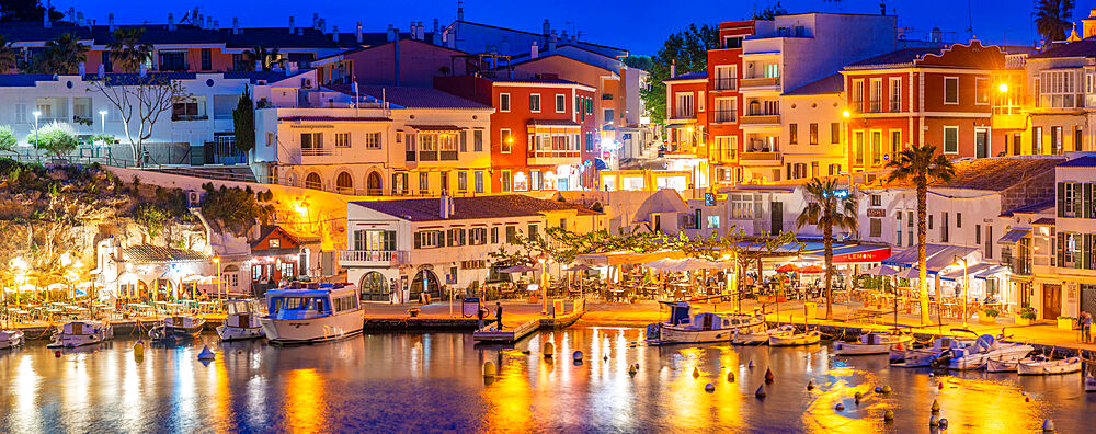 View of cafes, restaurants and boats in harbour at dusk, Cales Fonts, Es Castell, Menorca, Balearic Islands, Spain, Mediterranean, Europe