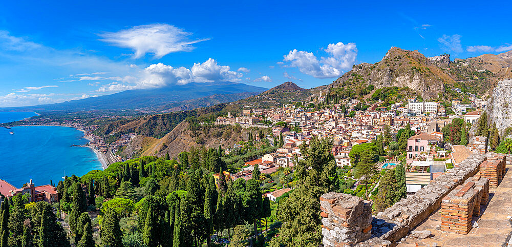 View of Taormina with Mount Etna in the background from the Greek Theatre, Taormina, Sicily, Italy, Mediterranean, Europe