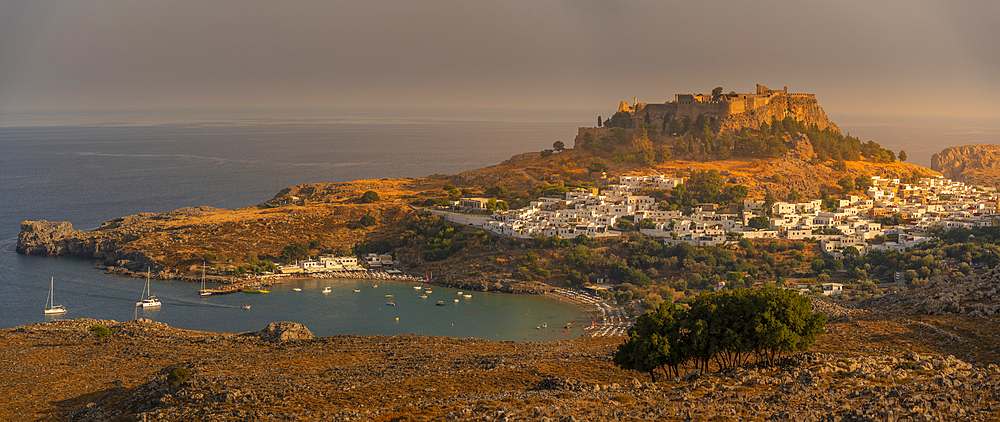 View of sailboats in the bay, Lindos and Lindos Acropolis from elevated position, Lindos, Rhodes, Dodecanese Island Group, Greek Islands, Greece, Europe