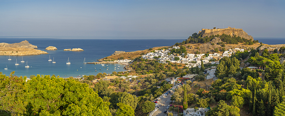 View of sailboats in the bay, Lindos and Lindos Acropolis from elevated position, Lindos, Rhodes, Dodecanese Island Group, Greek Islands, Greece, Europe