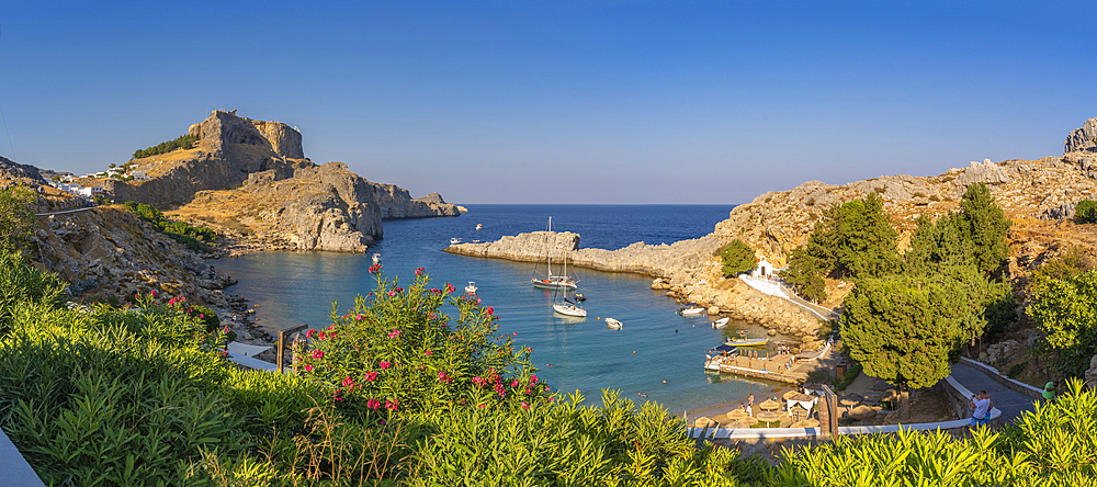 View of sailboats in the bay, Lindos and Lindos Acropolis from elevated position, Lindos, Rhodes, Dodecanese Island Group, Greek Islands, Greece, Europe