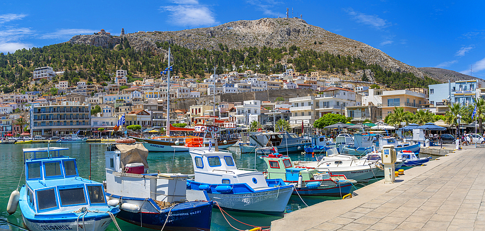 View of harbour boats in Kalimnos with hills in the background, Kalimnos, Dodecanese Islands, Greek Islands, Greece, Europe