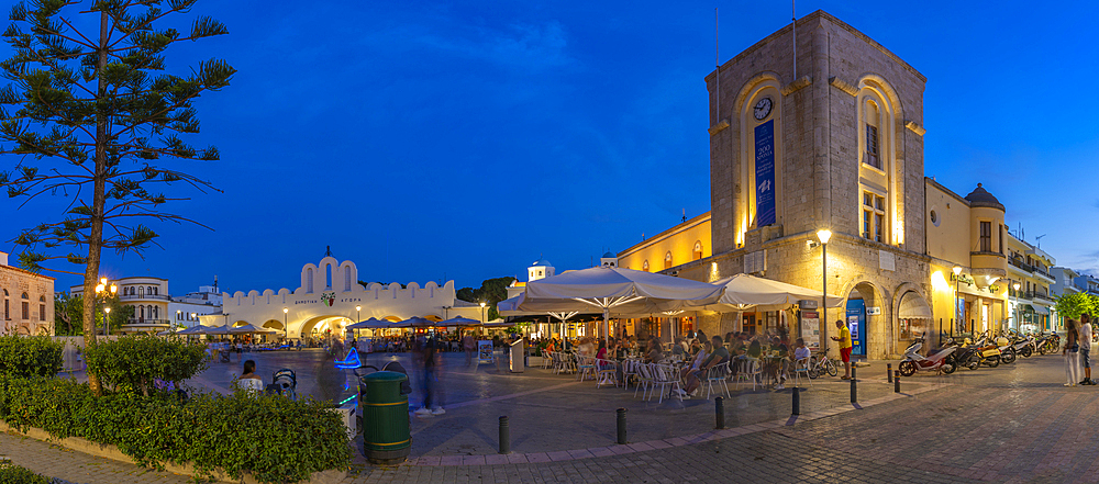 View of cafe and restaurant in Eleftherias Central Square in Kos Town at dusk, Kos, Dodecanese, Greek Islands, Greece, Europe