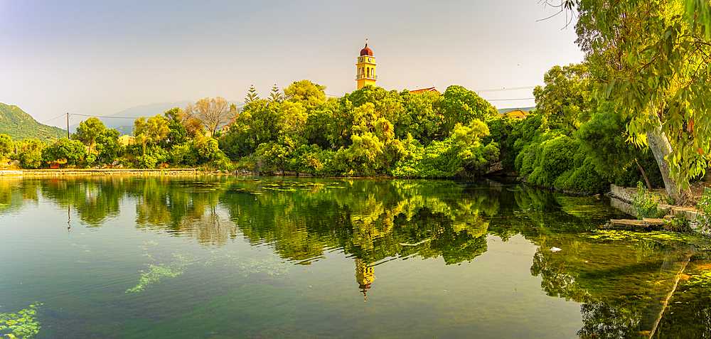 View of church reflecting in Karavomilos Lake in Sami, Sami, Kefalonia, Ionian Islands, Greek Islands, Greece, Europe