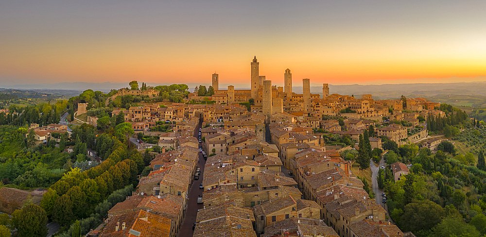 Elevated view of rooftops and town at sunrise, San Gimignano, Tuscany, Italy, Europe