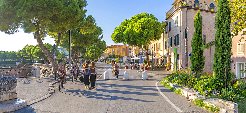 View of colourful buildings, cafe and cypress trees in Borgo San Giuliano, Rimini, Emilia-Romagna, Italy, Europe