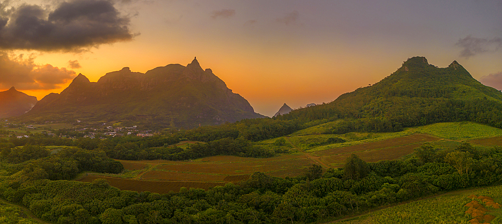 View of golden sunset behind Long Mountain and patchwork of green fields, Mauritius, Indian Ocean, Africa