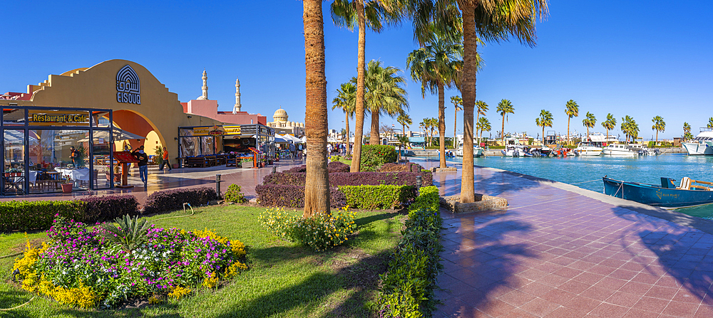 View of cafe and waterfront in Hurghada Marina and Al Mina Mosque in background, Hurghada, Red Sea Governorate, Egypt, North Africa, Africa