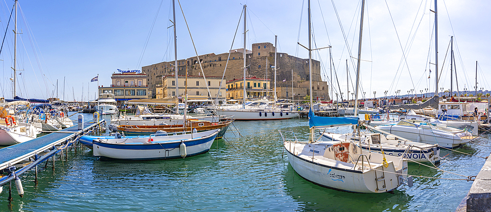 View of boats in harbour and Ovo Castle, historic centre, UNESCO World Heritage Site, Naples, Campania, Italy, Europe