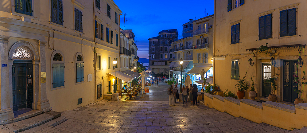 View of restaurants in Mitropolis Square, old Corfu Town at dusk, UNESCO World Heritage Site, Corfu, Ionian Sea, Greek Islands, Greece, Europe