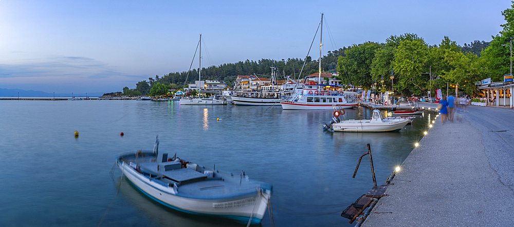 View of boats and harbour in Thassos Town at dusk, Thassos, Aegean Sea, Greek Islands, Greece, Europe