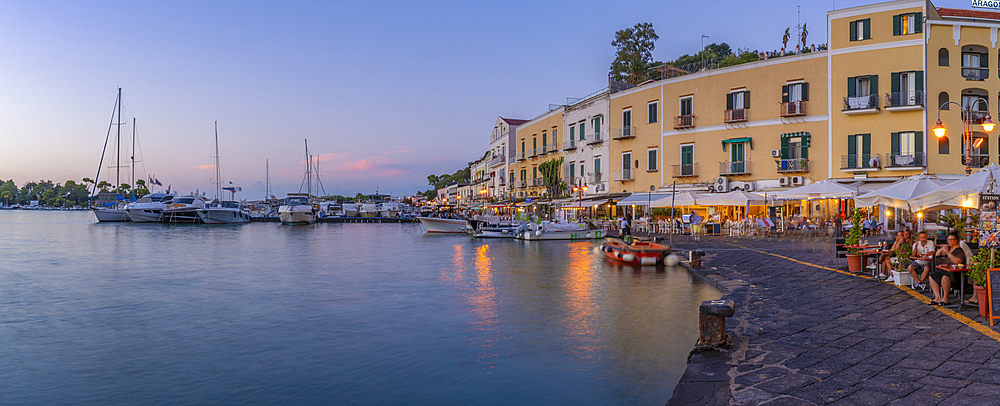 View of restaurants in Porto d'Ischia (Port of Ischia) at dusk, Island of Ischia, Campania, Italy, Europe