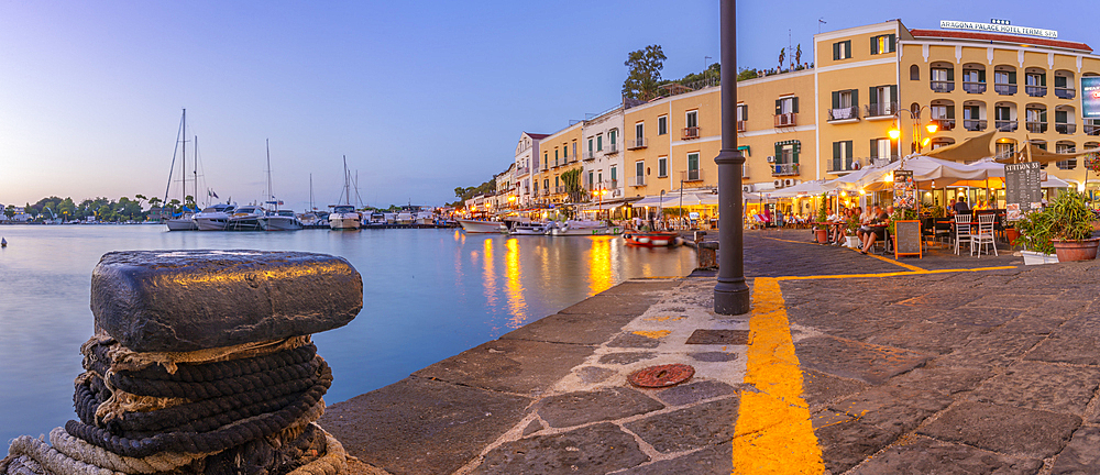 View of restaurants in Porto d'Ischia (Port of Ischia) at dusk, Island of Ischia, Campania, Italy, Europe