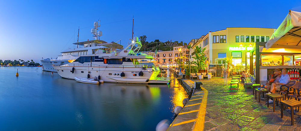 View of boats and restaurants in Porto d'Ischia (Port of Ischia) at dusk, Island of Ischia, Campania, Italy, Europe