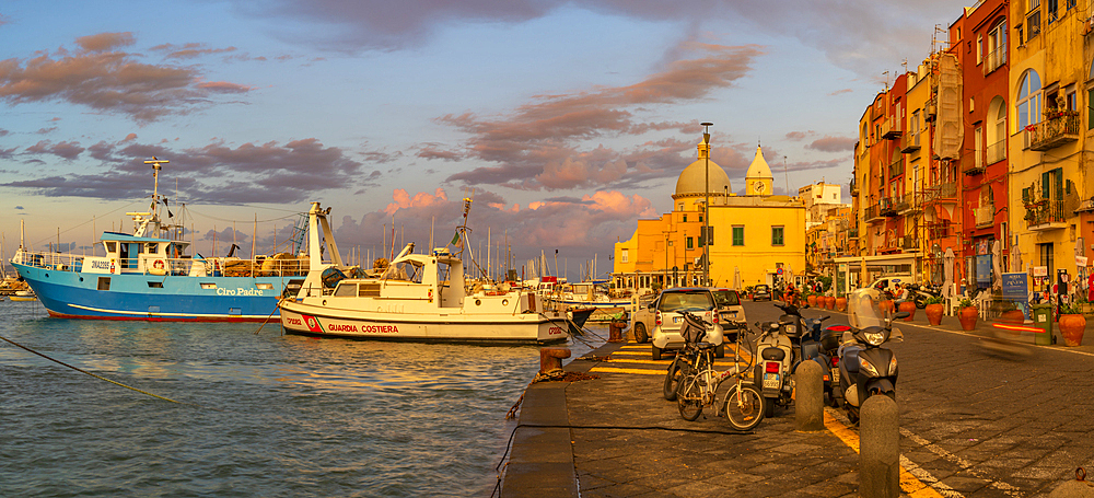 View of Church Madonna delle Grazie in the fishing port Marina Grande with shops at golden hour, Procida, Phlegraean Islands, Gulf of Naples, Campania, Southern Italy, Italy, Europe