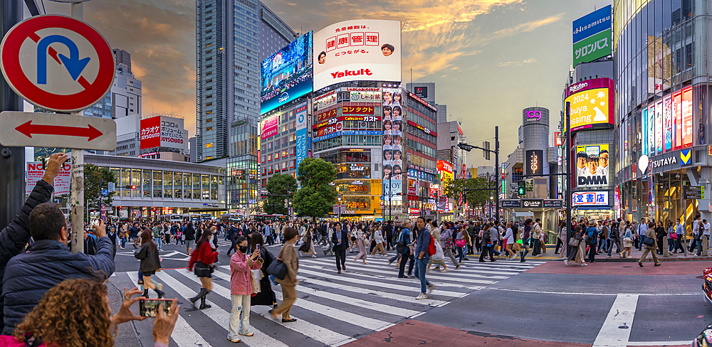 View of people at the world's busiest road crossing, Shibuya Scramble Crossing at sunset, Minato City, Tokyo, Japan, Asia