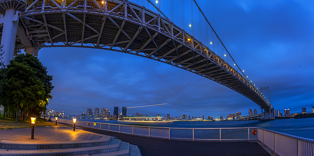 View of the Rainbow Bridge and Koto City in background at dusk, Minato City, Tokyo, Honshu, Japan, Asia