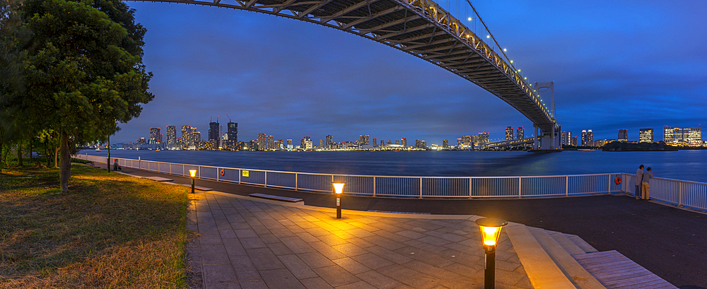 View of the Rainbow Bridge and Koto City in background at dusk, Minato City, Tokyo, Honshu, Japan