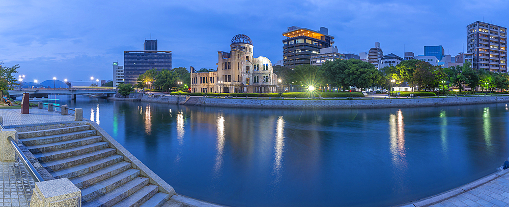 View of the skeletal ruins of the A-Bomb Dome from Hiroshima Peace Gardens at dusk, UNESCO, Hiroshima, Honshu, Japan