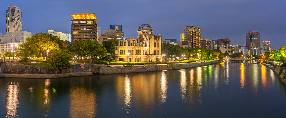 View of the skeletal ruins of the A-Bomb Dome from Hiroshima Peace Gardens at dusk, UNESCO, Hiroshima, Honshu, Japan