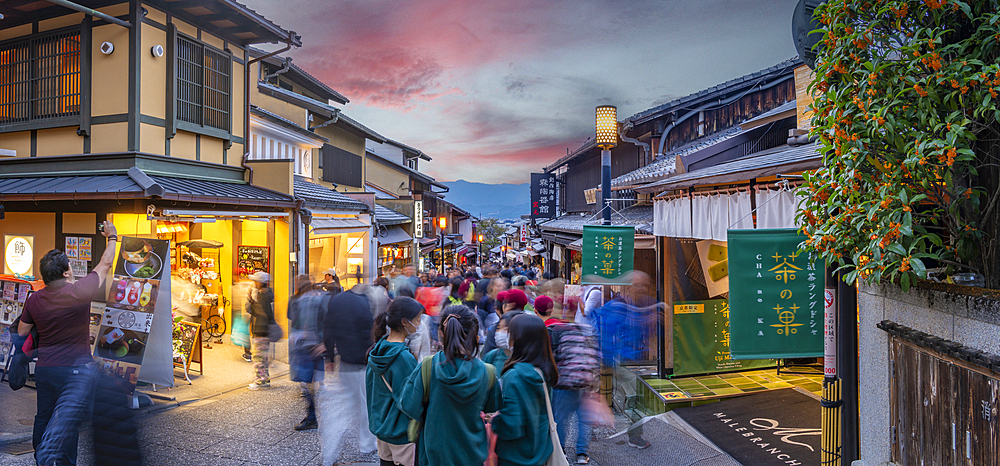 View of busy street and traditional wooden houses and shops in Gion, Kyoto Geisha District, Kyoto, Honshu, Japan