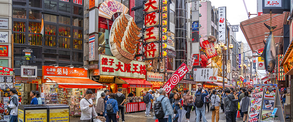 View of colourful signs of restaurants in Dotonbori, vibrant entertainment district near the river, Osaka, Honshu, Japan