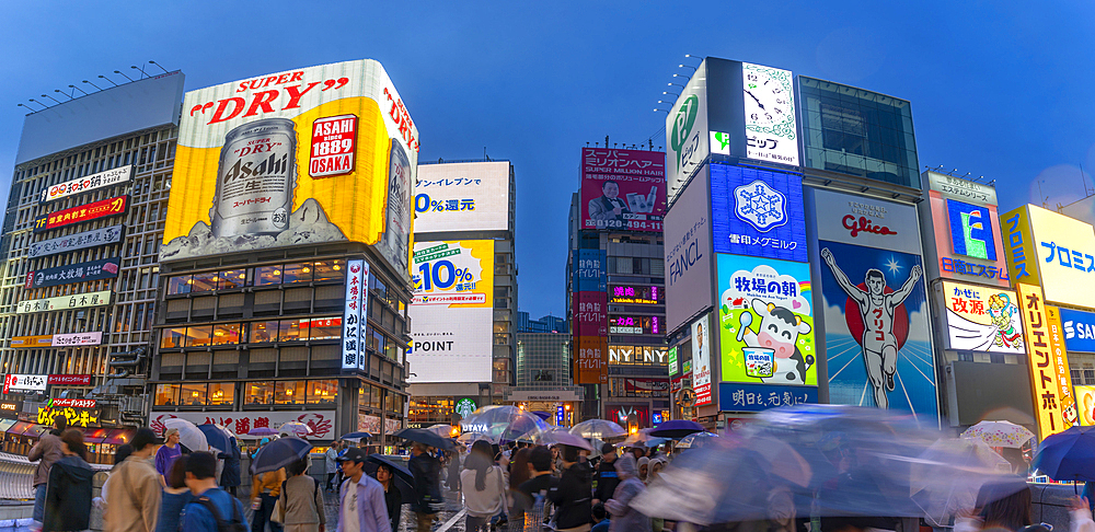 View of Glico sign of Dotonbori, vibrant entertainment district near the river at dusk, Osaka, Honshu, Japan, Asia